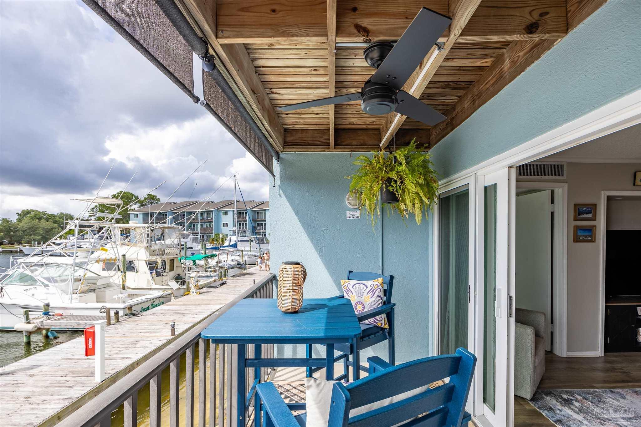 14100 River Road, Unit 122B Perdido Key, FL 32507 - Photo 21 of 46 a balcony with table and chairs