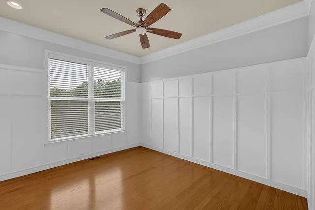 a balcony with wooden floor table and chairs