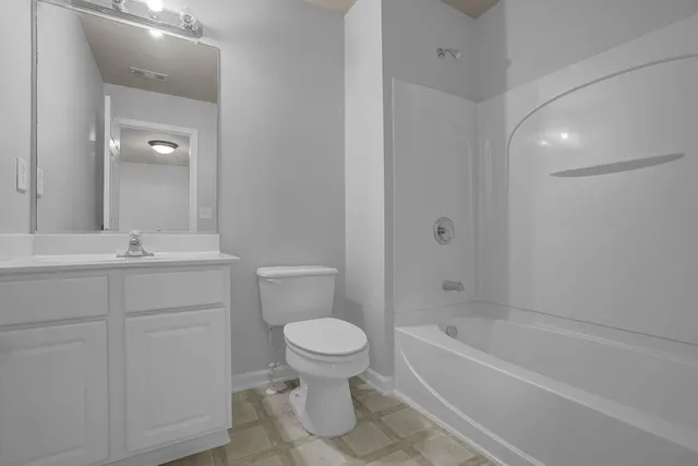 a bathroom with a sink a toilet and shower curtain