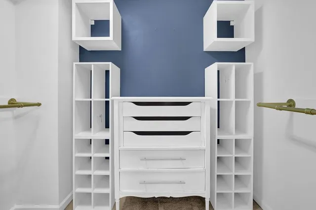 a view of empty room with fireplace and wooden floor