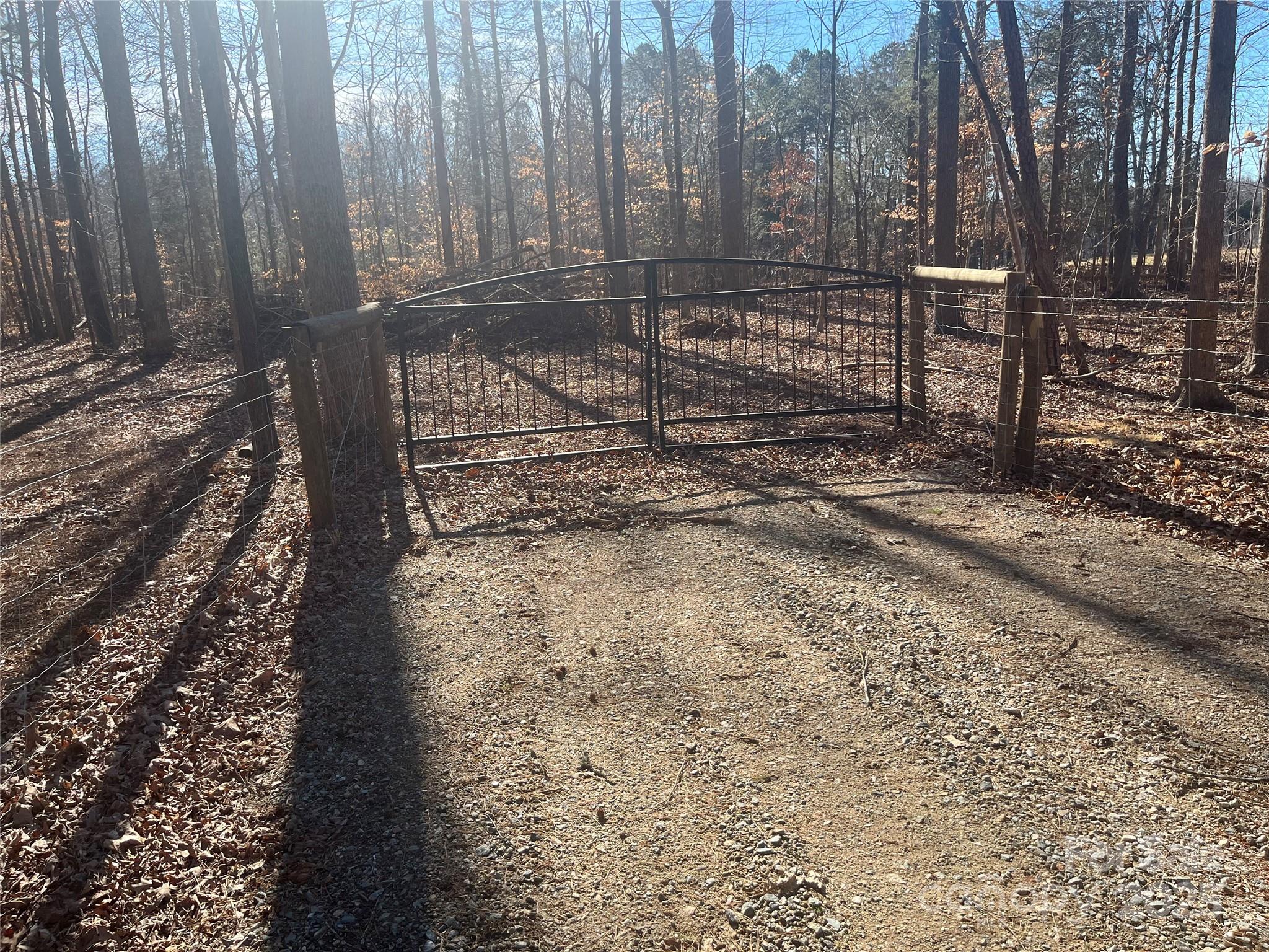 15.009-acres Archer Road Davidson, NC 28036 - Photo 6 of 14 a view of a yard with wooden fence