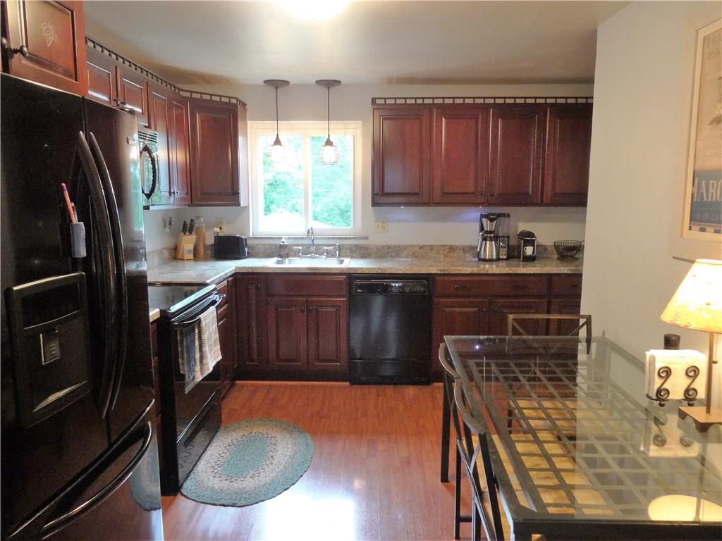 4206 Greenridge Road Pittsburgh, PA 15234 - Photo 4 of 25 Eat-in kitchen with cherry cabinetry and easy-care laminate flooring