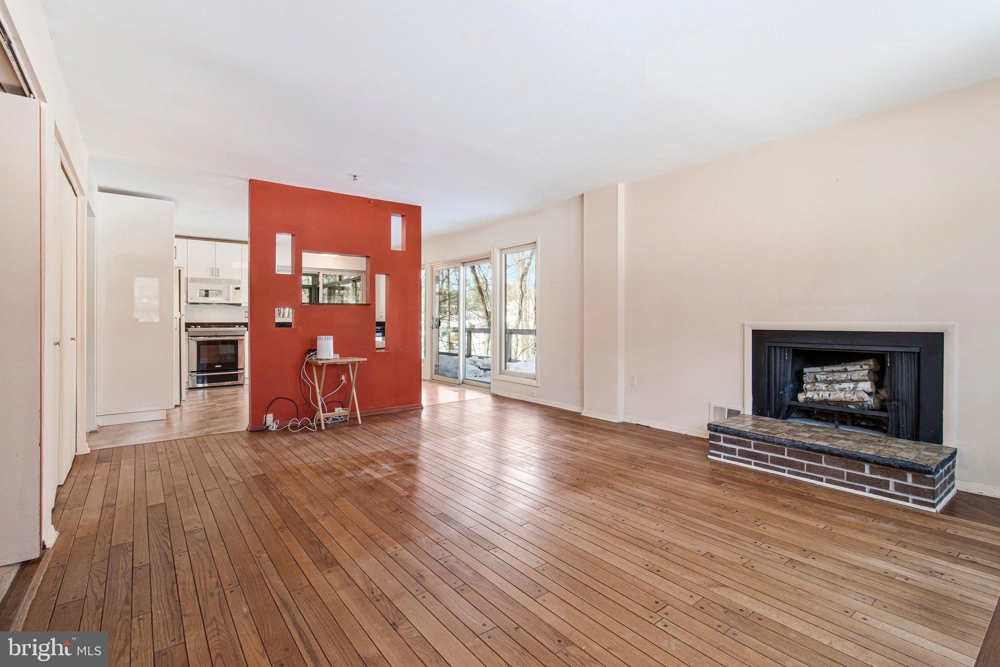 14816 Stonegate Terrace Silver Spring, MD 20905 - Photo 22 of 79 a view of a livingroom with wooden floor and a fireplace