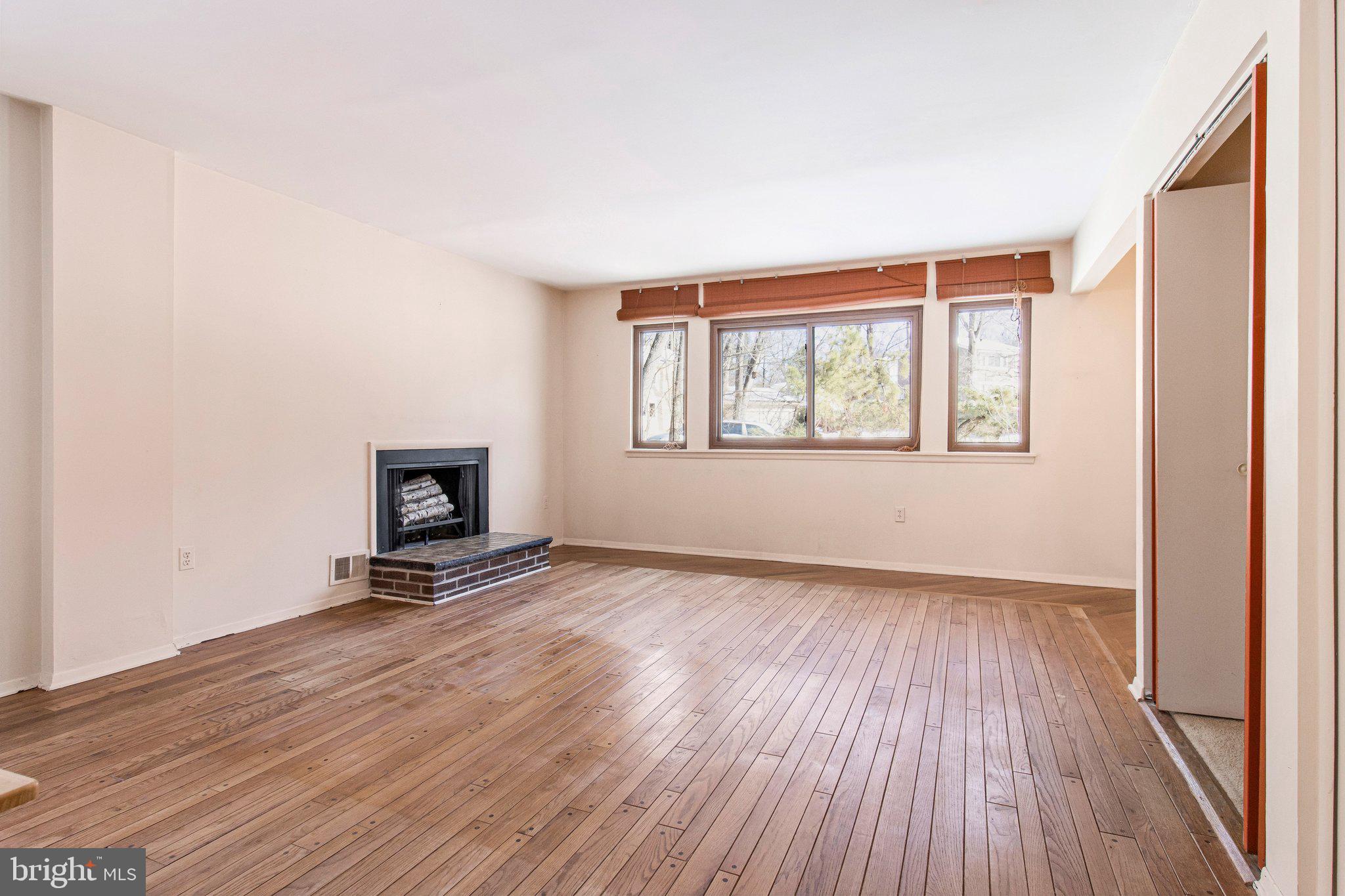 14816 Stonegate Terrace Silver Spring, MD 20905 - Photo 24 of 79 a view of an empty room with a window and wooden floor