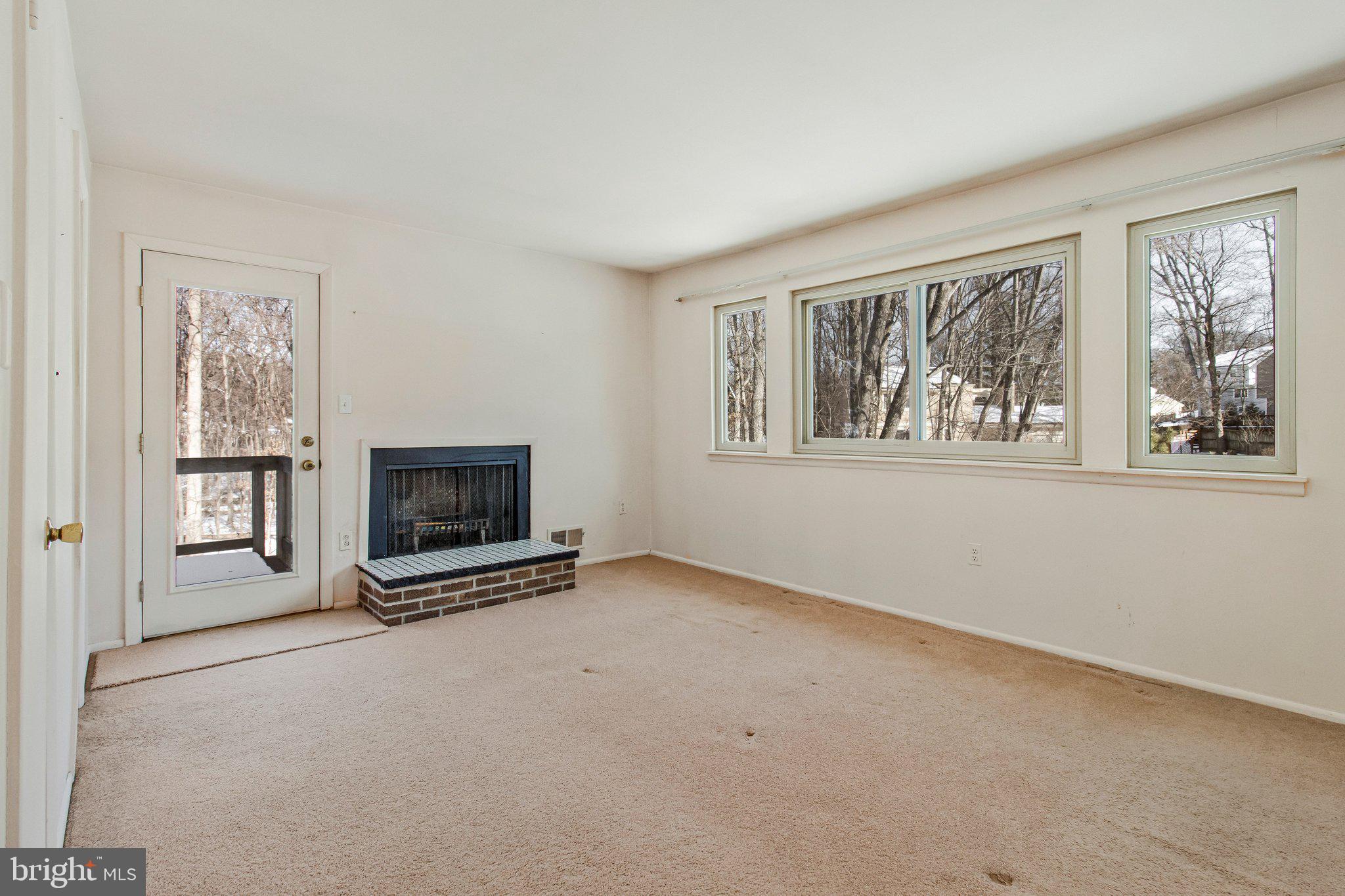 14816 Stonegate Terrace Silver Spring, MD 20905 - Photo 38 of 79 wooden floor fireplace and windows in an empty room