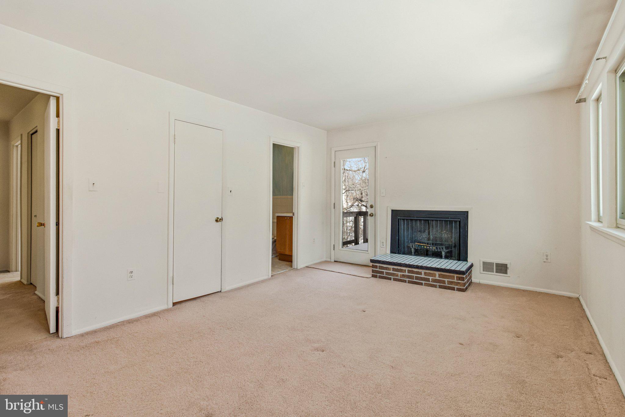 14816 Stonegate Terrace Silver Spring, MD 20905 - Photo 40 of 79 an empty room with a fireplace and a window