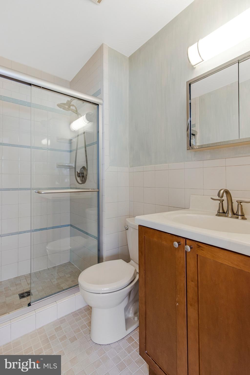 14816 Stonegate Terrace Silver Spring, MD 20905 - Photo 44 of 79 a bathroom with a toilet a sink and shower