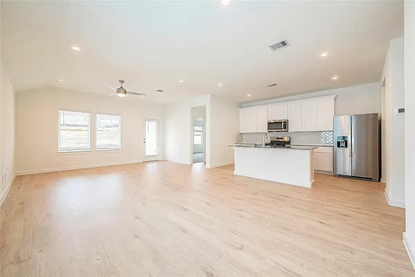 a view of a kitchen with a sink and a refrigerator