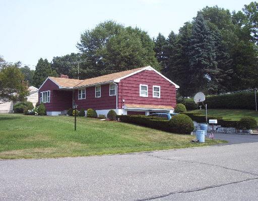 a front view of a house with a garden and yard