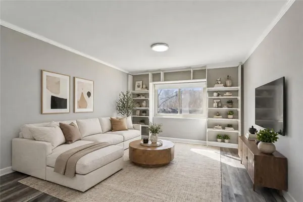 a living room with furniture and a flat screen tv