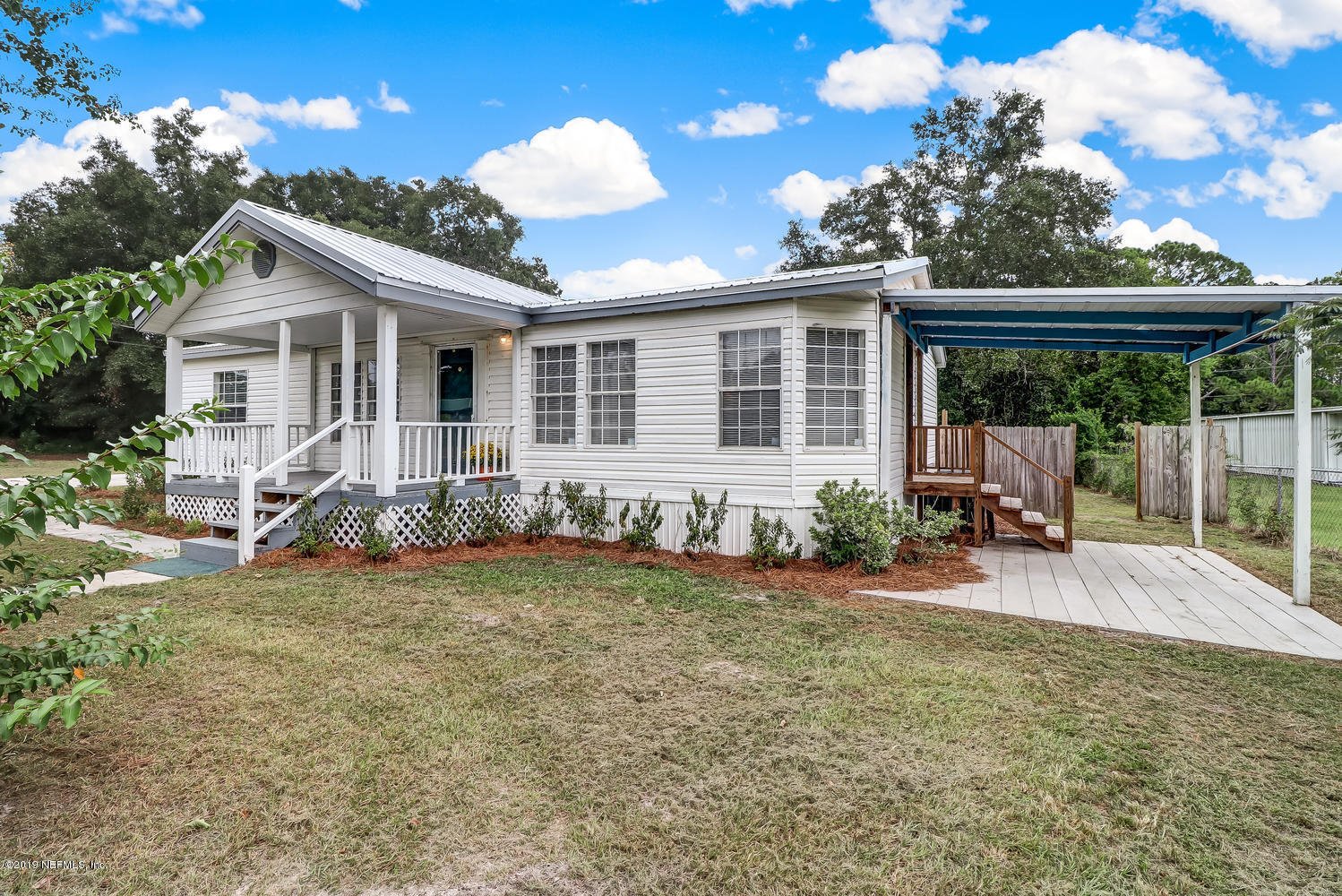85354 Winona Bayview Road Yulee, FL 32097 - Photo 1 of 27 a view of a house with backyard and porch