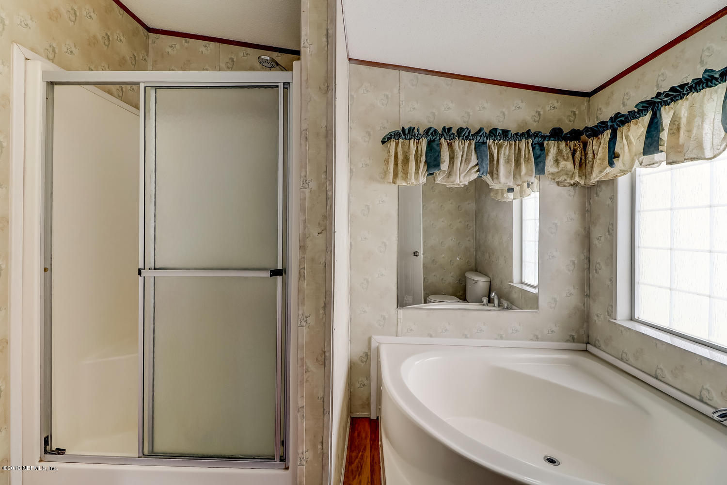 85354 Winona Bayview Road Yulee, FL 32097 - Photo 17 of 27 a bathroom with a sink and a shower a mirror
