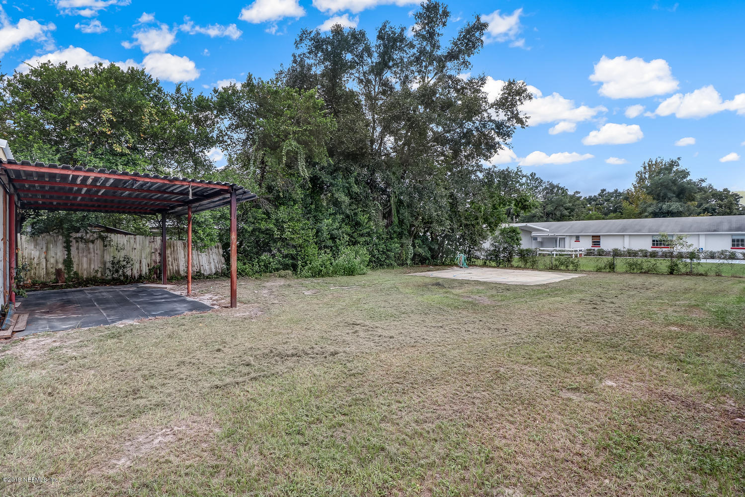 85354 Winona Bayview Road Yulee, FL 32097 - Photo 25 of 27 a view of a barn with a yard and large tree