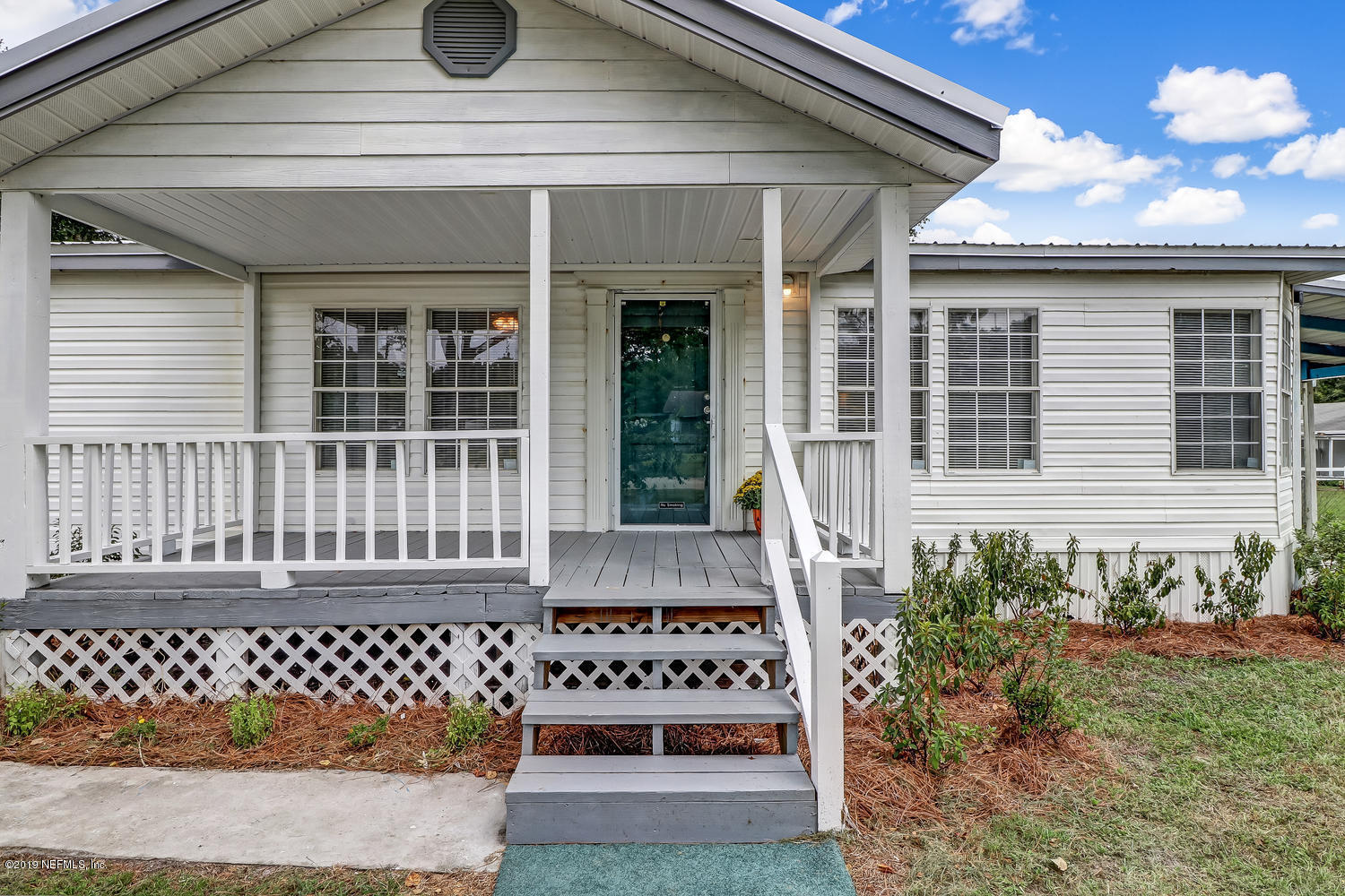 85354 Winona Bayview Road Yulee, FL 32097 - Photo 3 of 27 a front view of a house with a garden