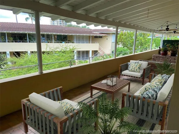 a balcony with furniture and a garden
