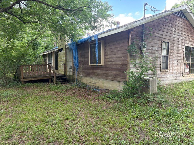 10580 Greenridge Road Conroe, TX 77303 - Photo 10 of 10 a backyard of a house with a garden and barbeque oven