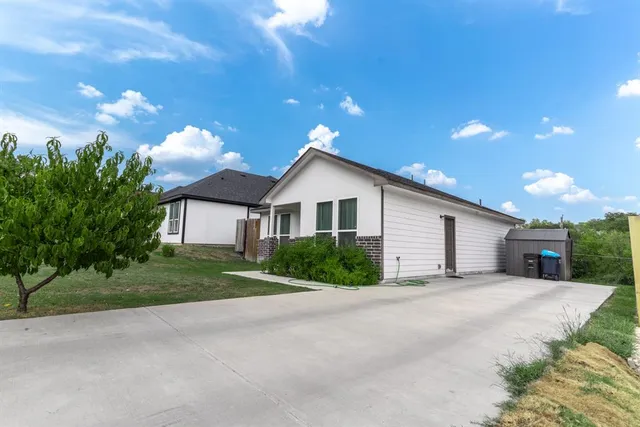 a view of a house with a yard and garage