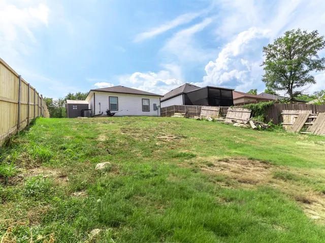 a big white house with a big yard and large trees