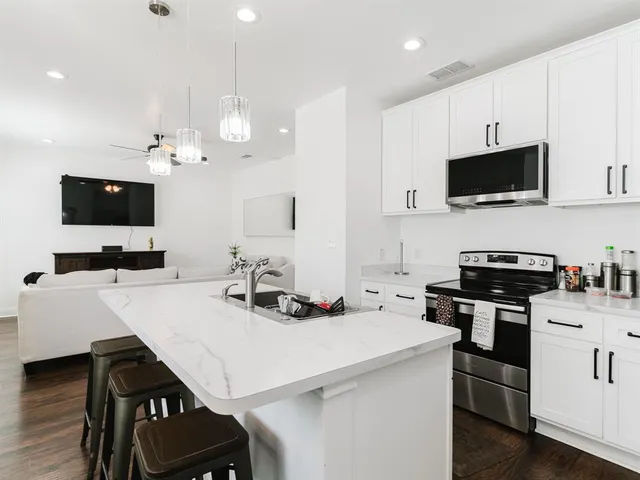 a kitchen that has a sink and a stove top oven