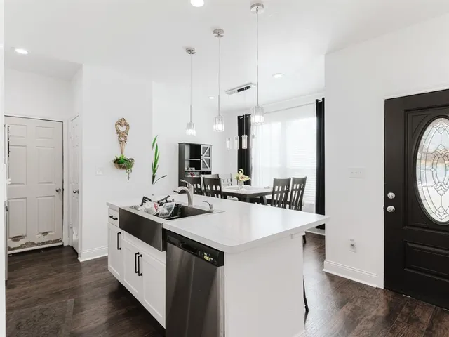 a kitchen with sink cabinets and wooden floor