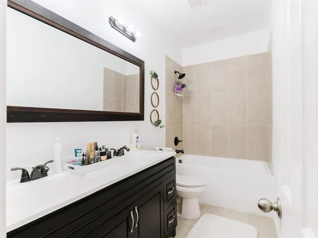 a bathroom with a sink a toilet and shower curtain