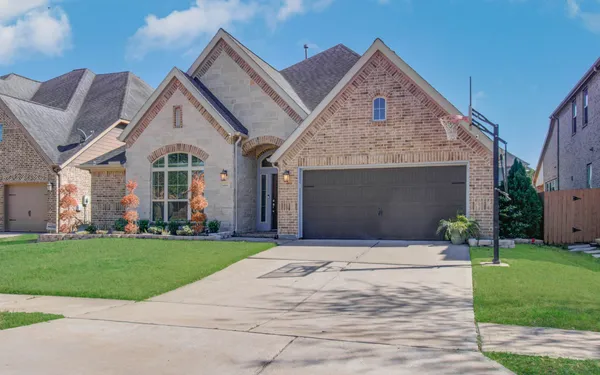 a front view of a house with a yard and garage