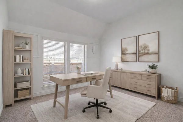a view of a workspace with furniture and window