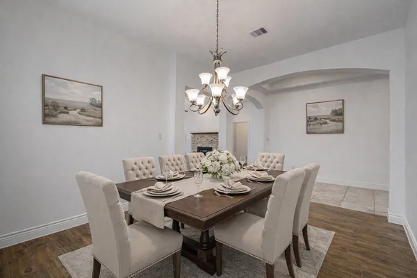 a view of a dining room with furniture wooden floor and a chandelier