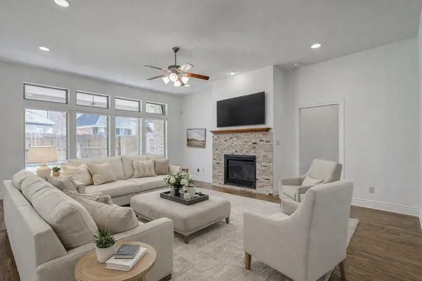a living room with furniture a fireplace and a flat screen tv