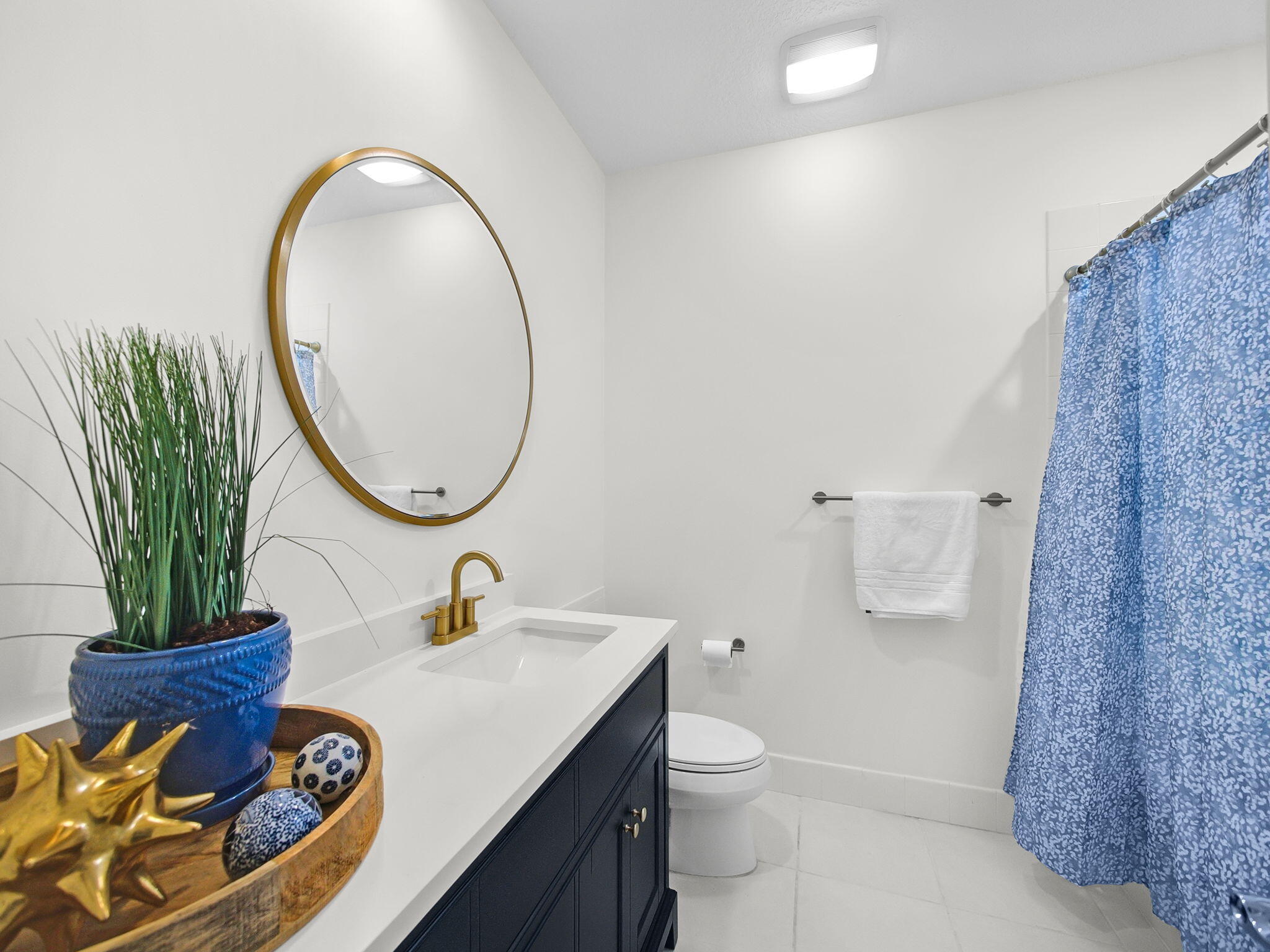 3119 East Community Drive Jupiter, FL 33458 - Photo 11 of 24 a bathroom with a sink mirror and toilet