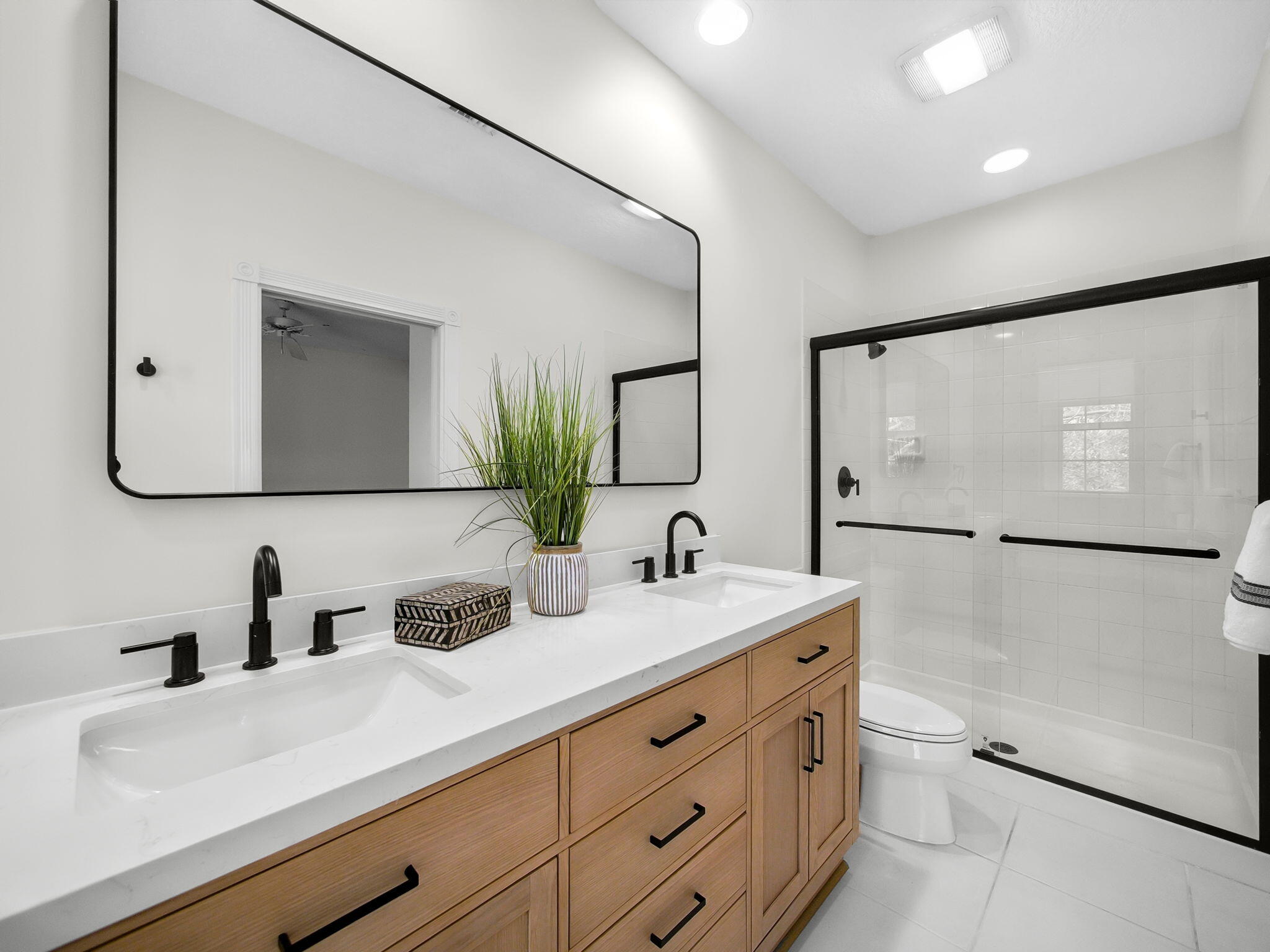 3119 East Community Drive Jupiter, FL 33458 - Photo 8 of 24 a bathroom with a double vanity sink mirror and double