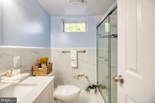 a white toilet sitting next to a bathroom sink