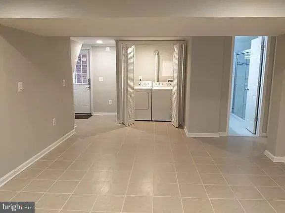 a view of a hallway with closet and a bathroom