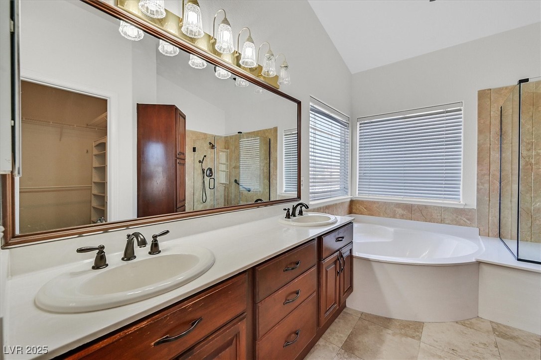 234 Highgate Street Henderson, NV 89074 - Photo 14 of 22 Full bath with a stall shower, lofted ceiling, a garden tub, double vanity, and a spacious closet
