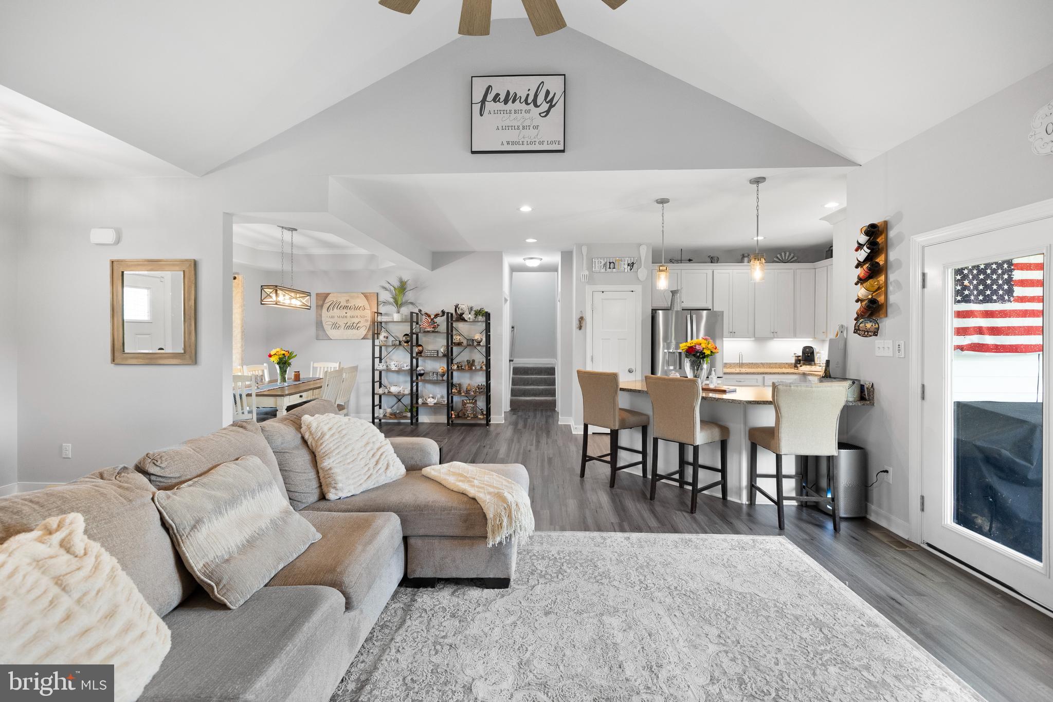 5175 Paynes Mill Road Bumpass, VA 23024 - Photo 20 of 55 a living room with furniture and a dining table with kitchen view