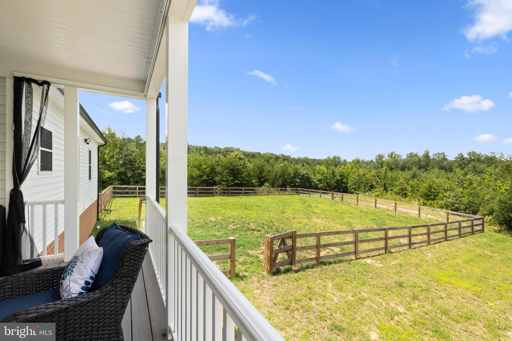 5175 Paynes Mill Road Bumpass, VA 23024 - Photo 50 of 55 a view of a lake with a garden and deck