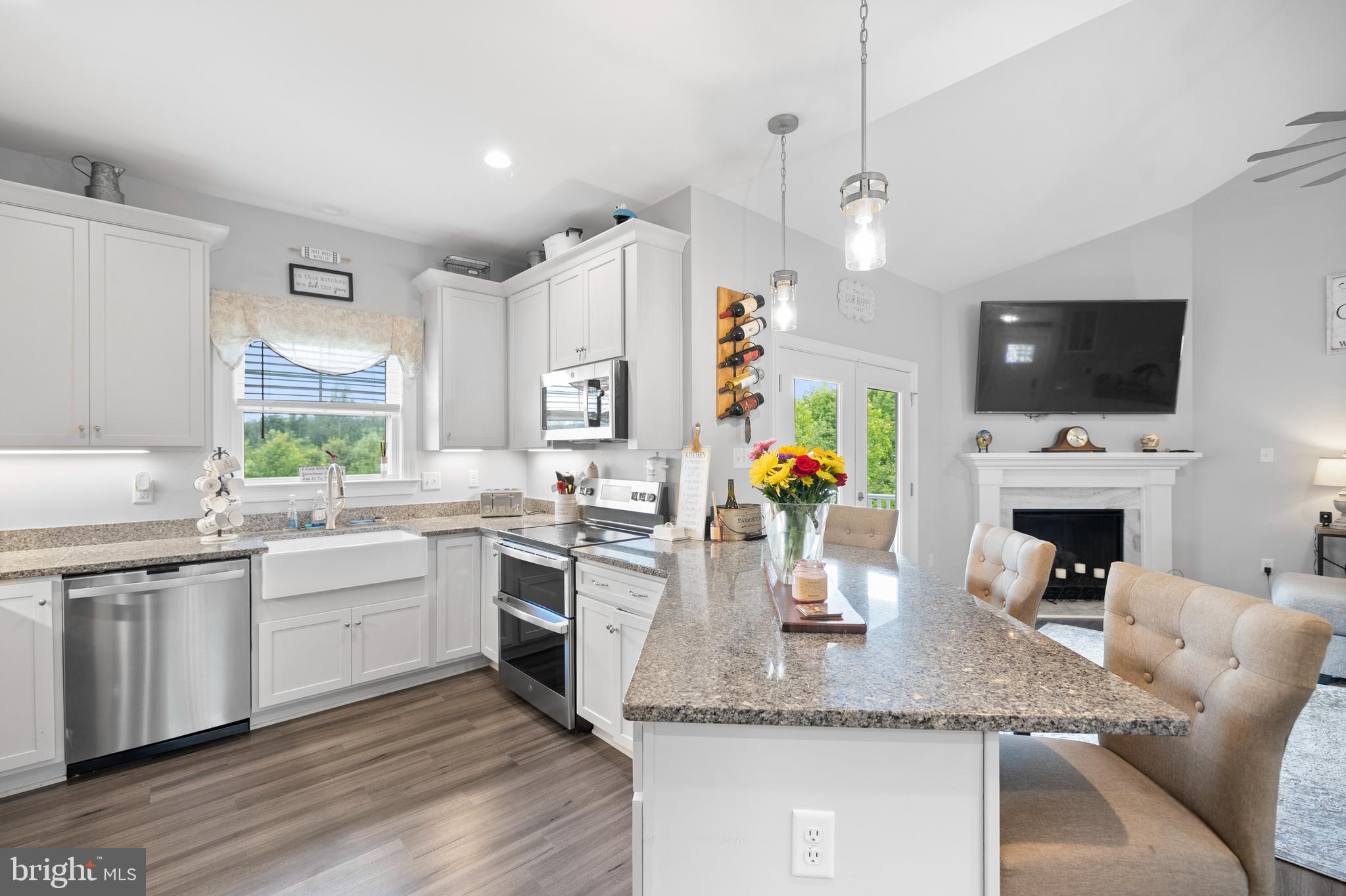 5175 Paynes Mill Road Bumpass, VA 23024 - Photo 5 of 55 a kitchen with stainless steel appliances granite countertop a sink a stove and microwave with wooden floor