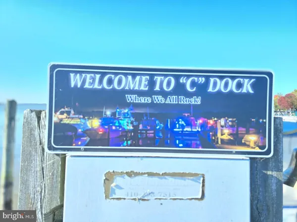 a wooden floor with a book and a bed