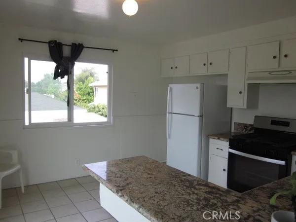 a kitchen with a stove and a refrigerator