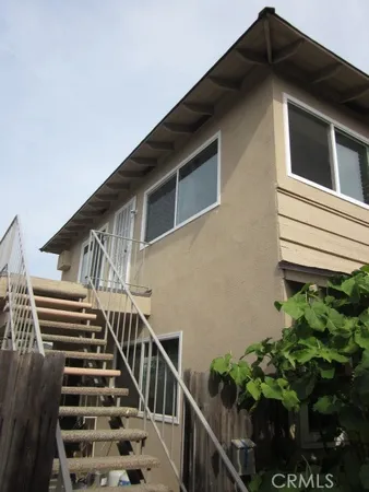 a view of a house with wooden fence