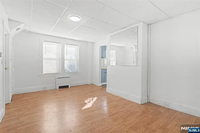 an empty room with windows and closet