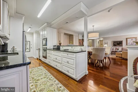 a large kitchen with stainless steel appliances kitchen island granite countertop a large island in the center