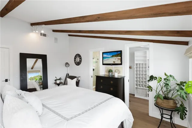 a view of a patio with couches table and chairs under an umbrella with a barbeque grill and couches