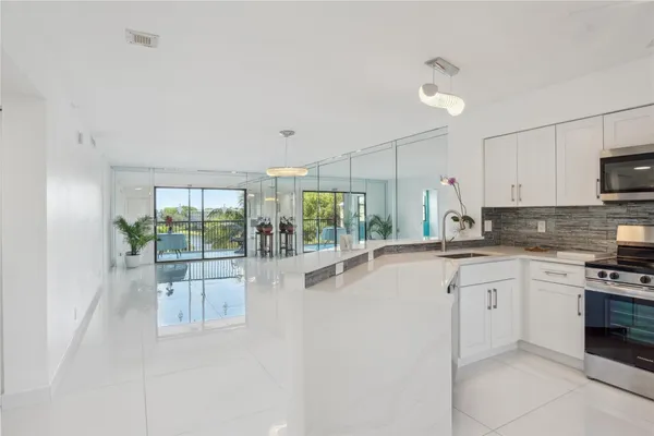 a kitchen with appliances cabinets and a sink