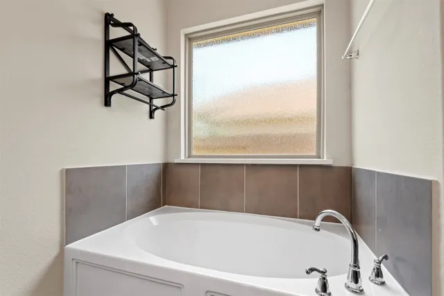 a bathroom with a bathtub and window