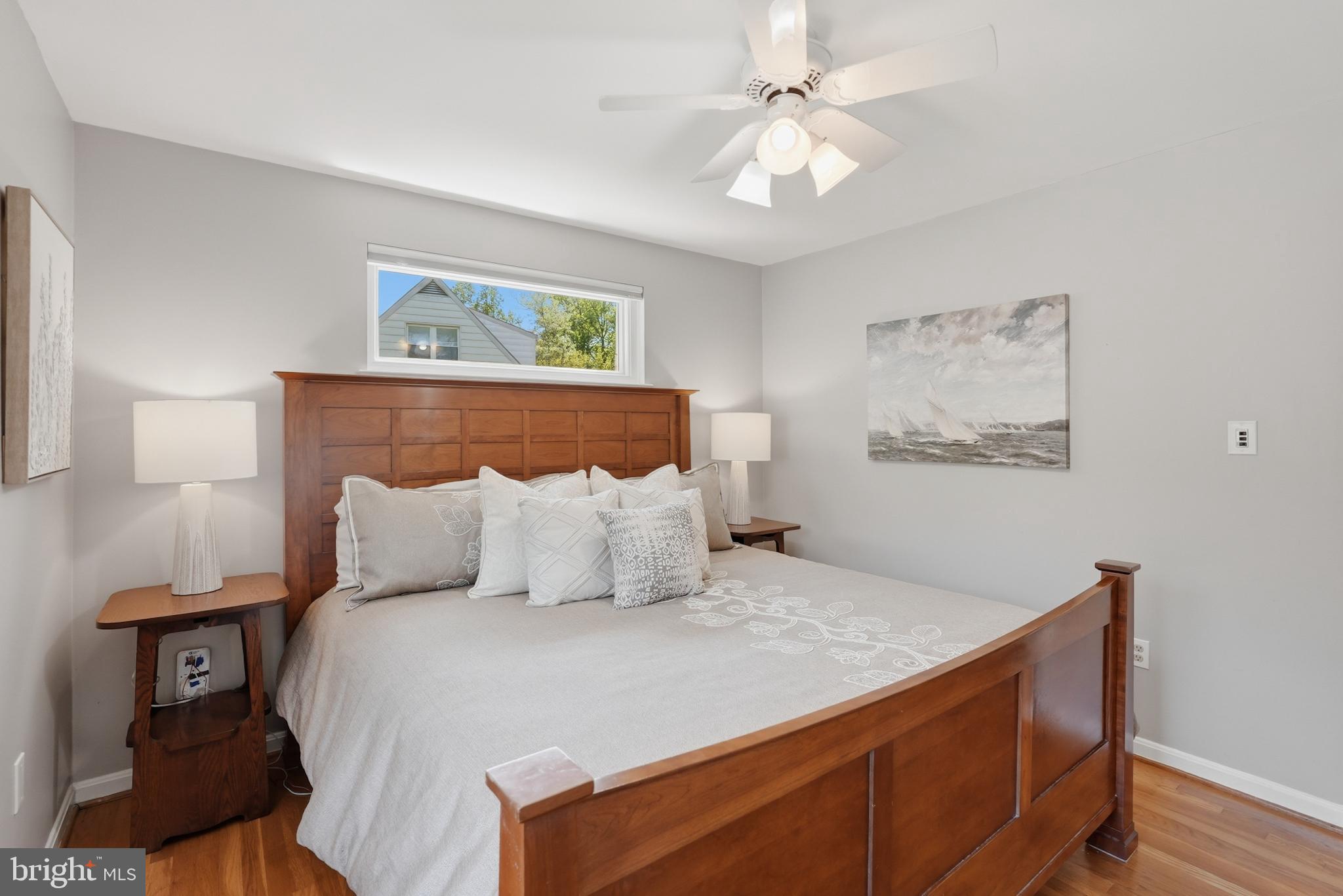 7006 Barnack Drive Springfield, VA 22152 - Photo 22 of 56 a bedroom with a large bed and a chandelier