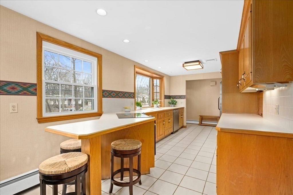 24 Oregon Road Ashland, MA 01721 - Photo 11 of 42 a large kitchen with a table and chairs in it