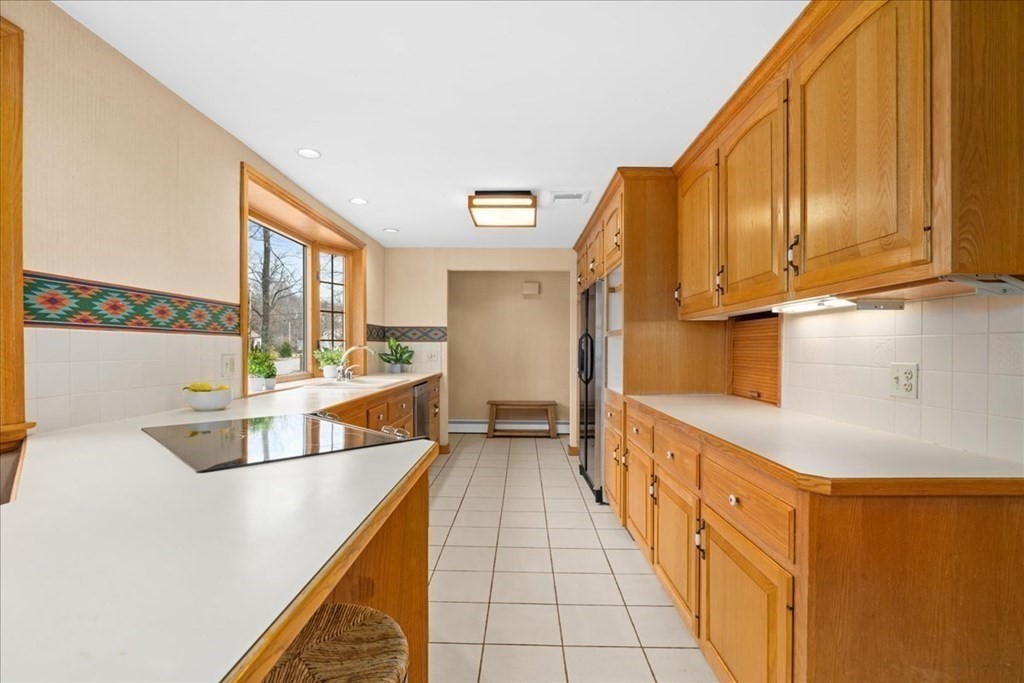 24 Oregon Road Ashland, MA 01721 - Photo 12 of 42 a kitchen with stainless steel appliances a sink and cabinets