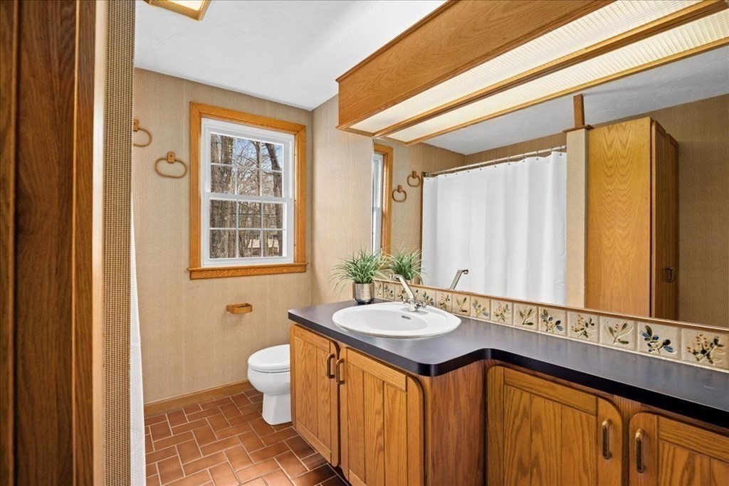 24 Oregon Road Ashland, MA 01721 - Photo 25 of 42 a bathroom with a granite countertop sink and a mirror