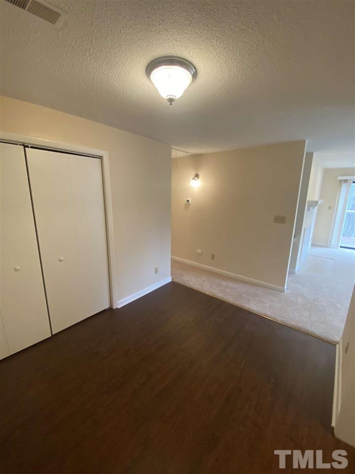 5820 Pointer Drive, Unit 202 Raleigh, NC 27609 - Photo 11 of 20 an empty room with a mirror